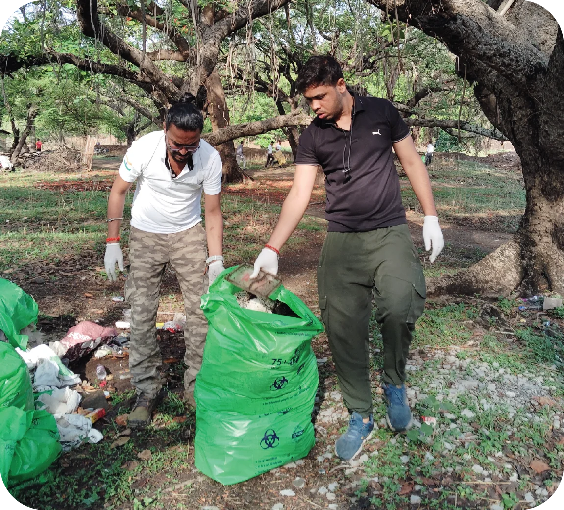 Volunteers holding garbage bags while preparing to collect waste